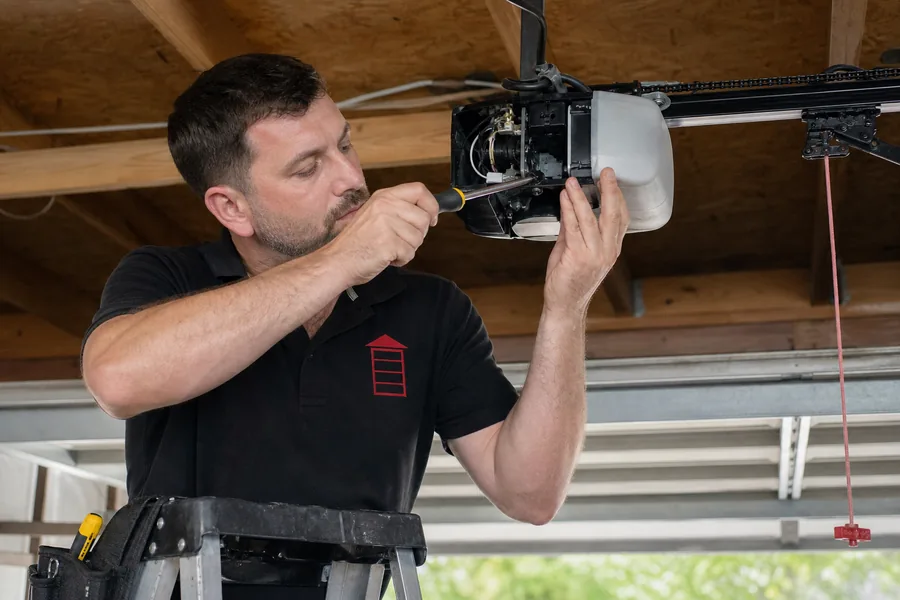 Emergency Garage Door Co technician repairing a garage door opener in Pittsburgh, PA