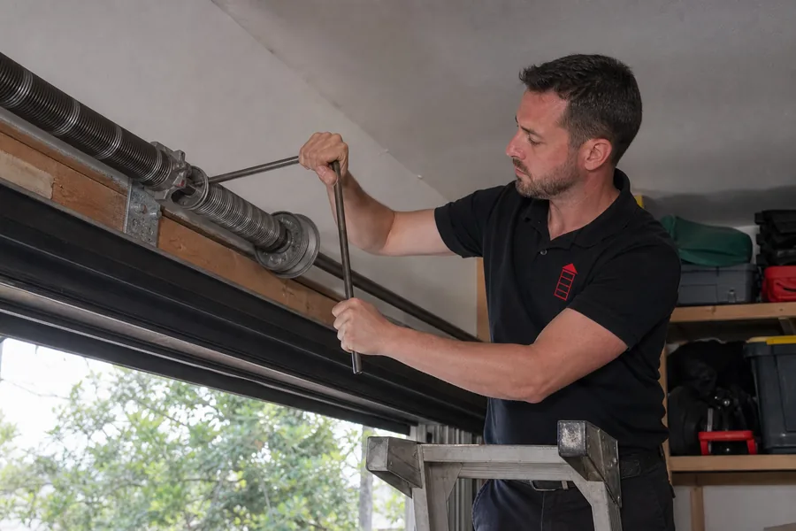 Emergency Garage Door Co technician replacing a broken torsion spring in Pittsburgh, PA